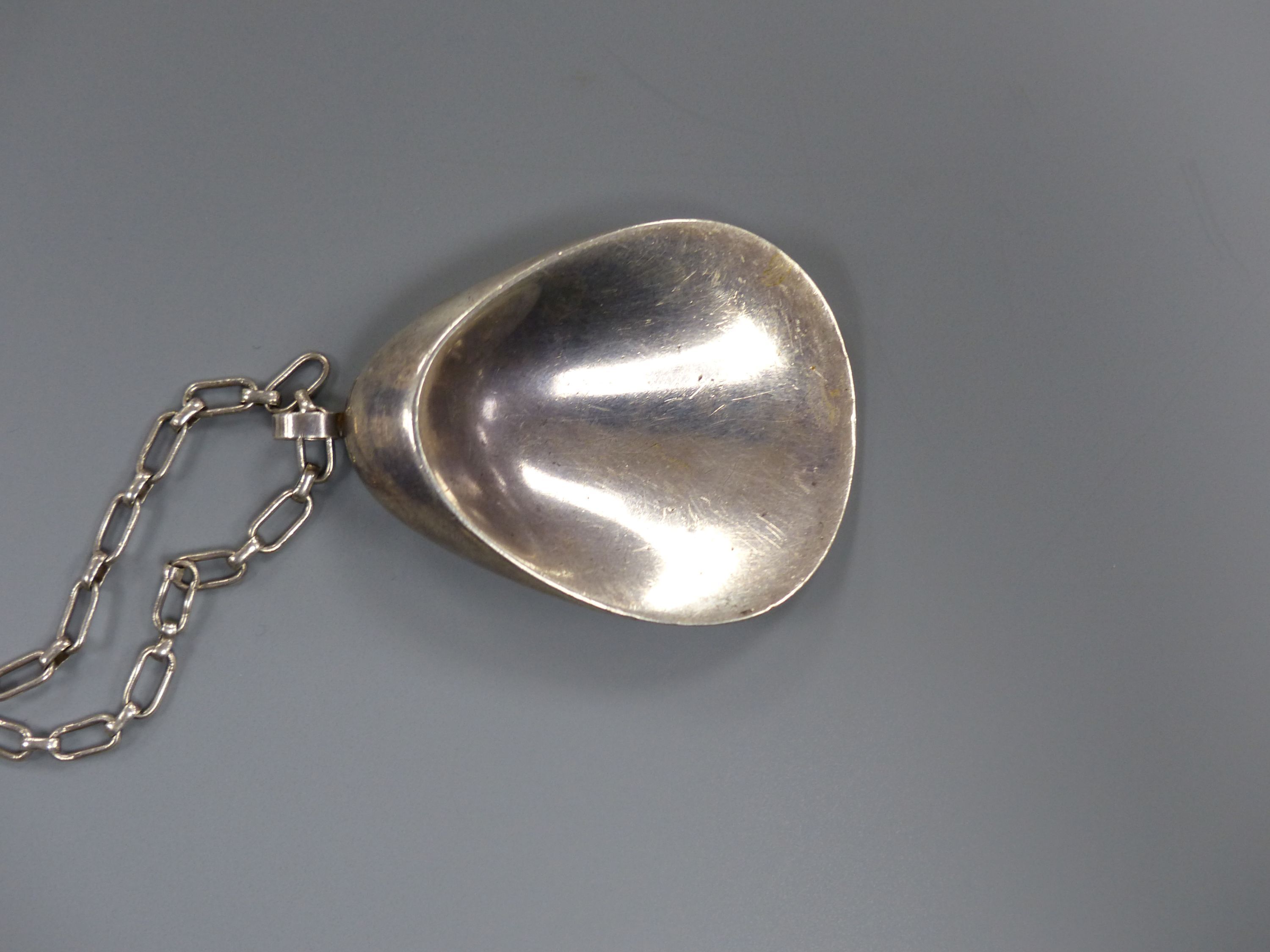 A 1960's Nanna & Jorgen Ditzel for Georg Jensen sterling oyster shell pendant, 60mm, design no 328, on a white metal chain, 84cm